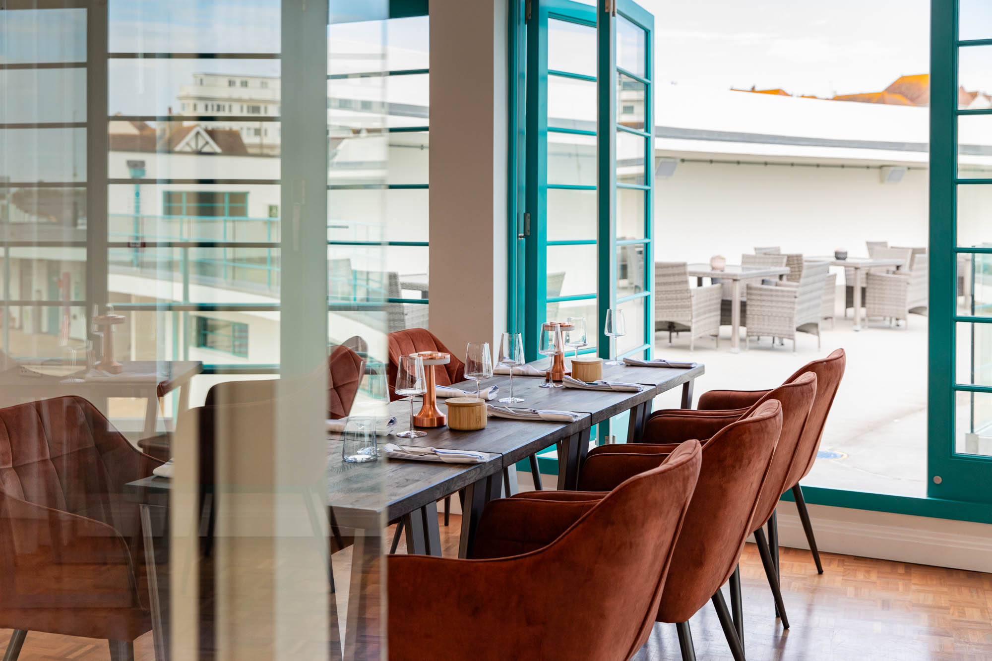Inside restaurant at Saltdean Lido showing table and chairs.