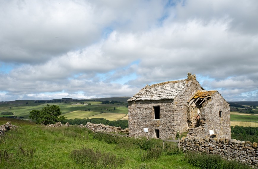 Spartalee house sitting in a hilly landscape in Weardale.