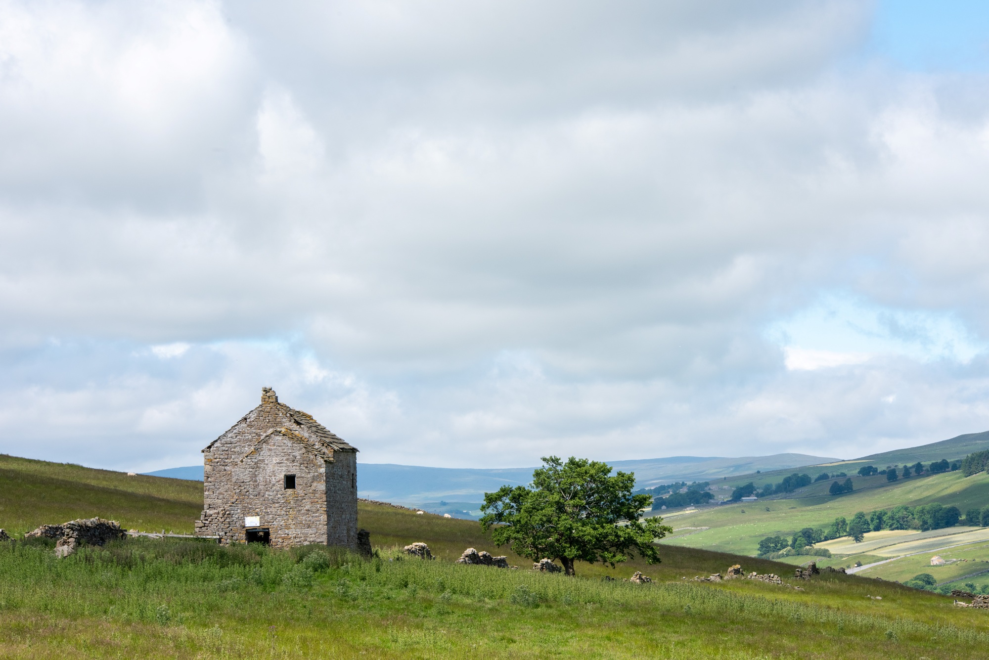 Spartalee house sitting in a hilly landscape in Weardale.